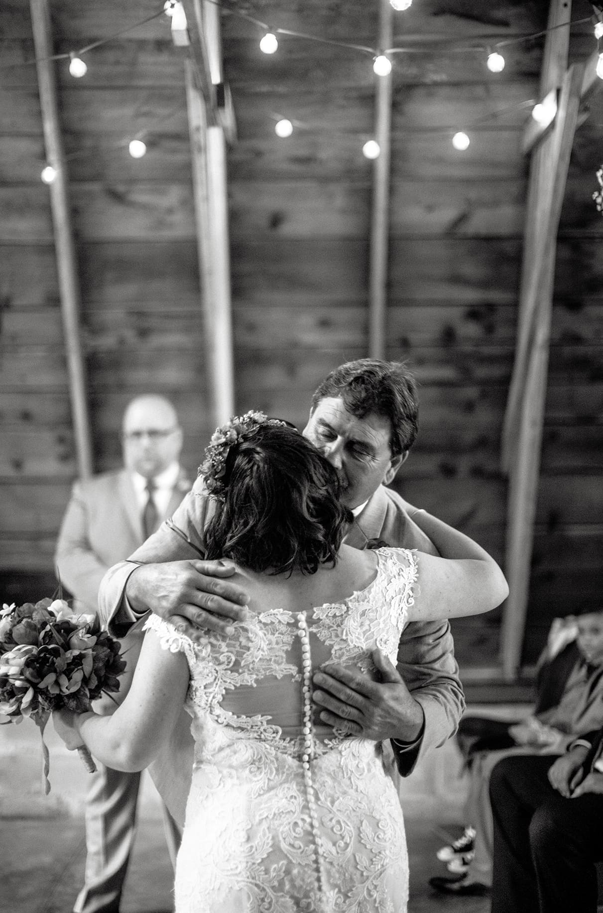 Father hugs bride as he gives her away at her wedding ceremony at Arlington Acres in Lafayette NY