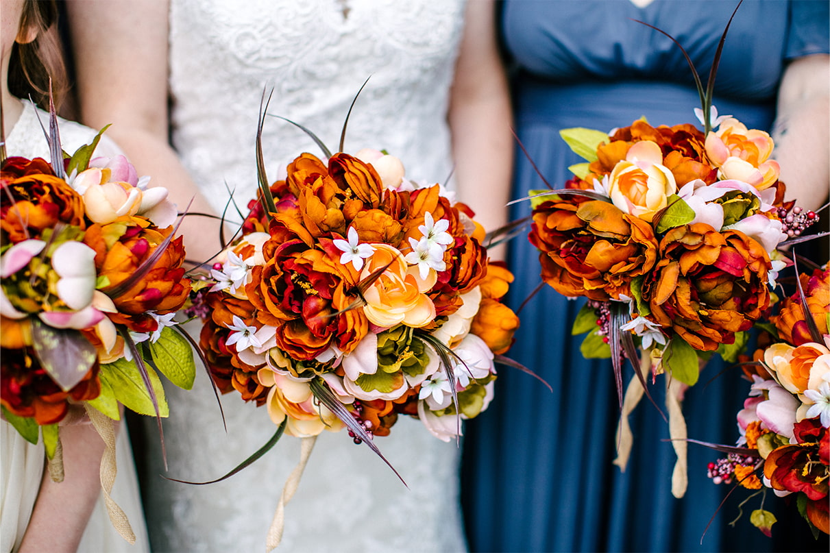 Bride and bridesmaids orange, fall bouquets at wedding in Arlington Acres in Lafayette NY