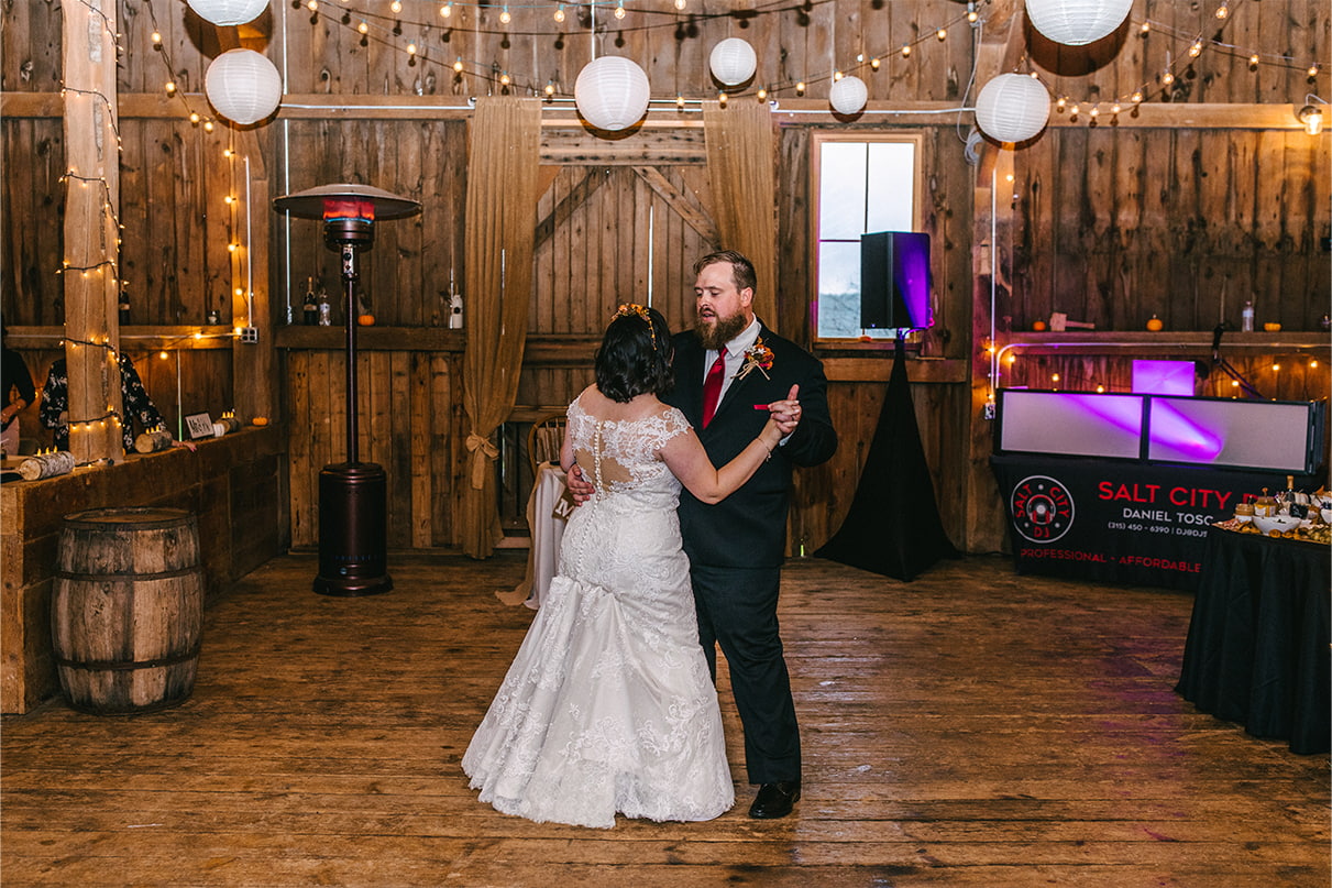 bride and groom have their first dance at wedding reception in barn at Arlington Acres in Lafayette NY
