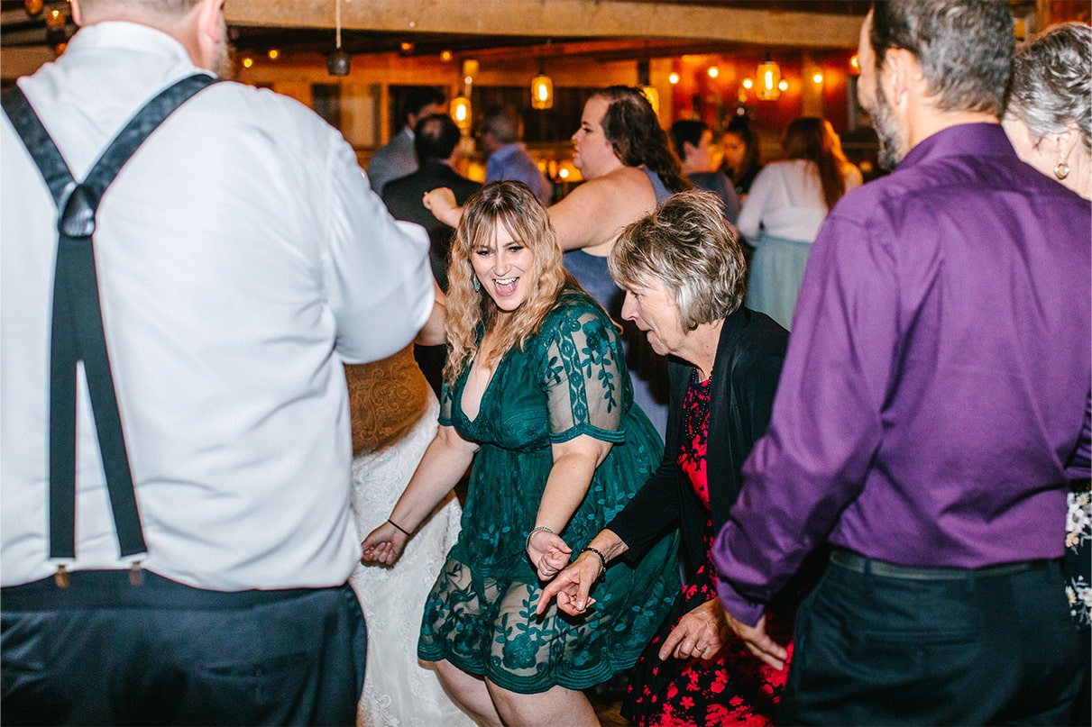 Wedding guests dance at reception in barn at Arlington Acres in Lafayette NY