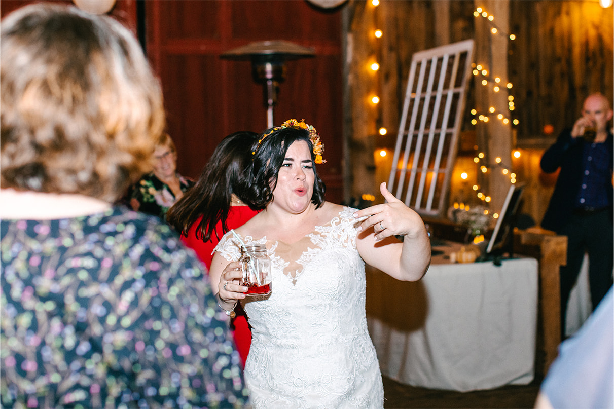 Bride dances during wedding reception at barn in Arlington Acres in Lafayette NY