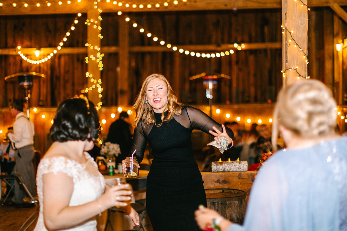 Wedding guests dance at reception in barn at Arlington Acres in Lafayette NY