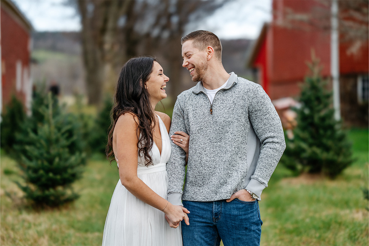 Couple looks at each other and laughs at at Sipples Farm in Bainbridge NY