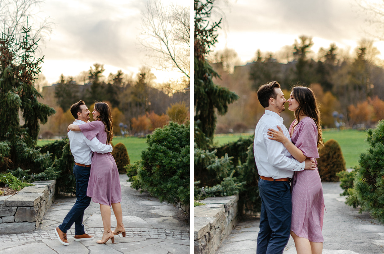 Couple embraces while dancing during garden golden-hour engagement session