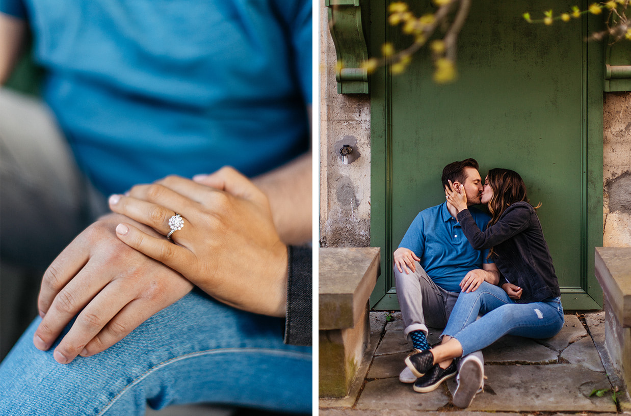 Couple with diamond engagement ring sitting in front of green door in Cornell Botanic Gardens in Ithaca NY