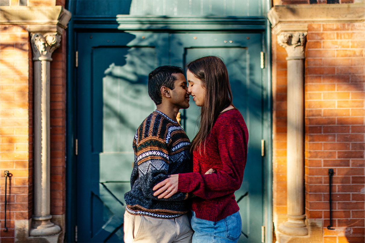 Couple almost kisses in front of Sage Chapel on Cornell University Campus in Ithaca, NY