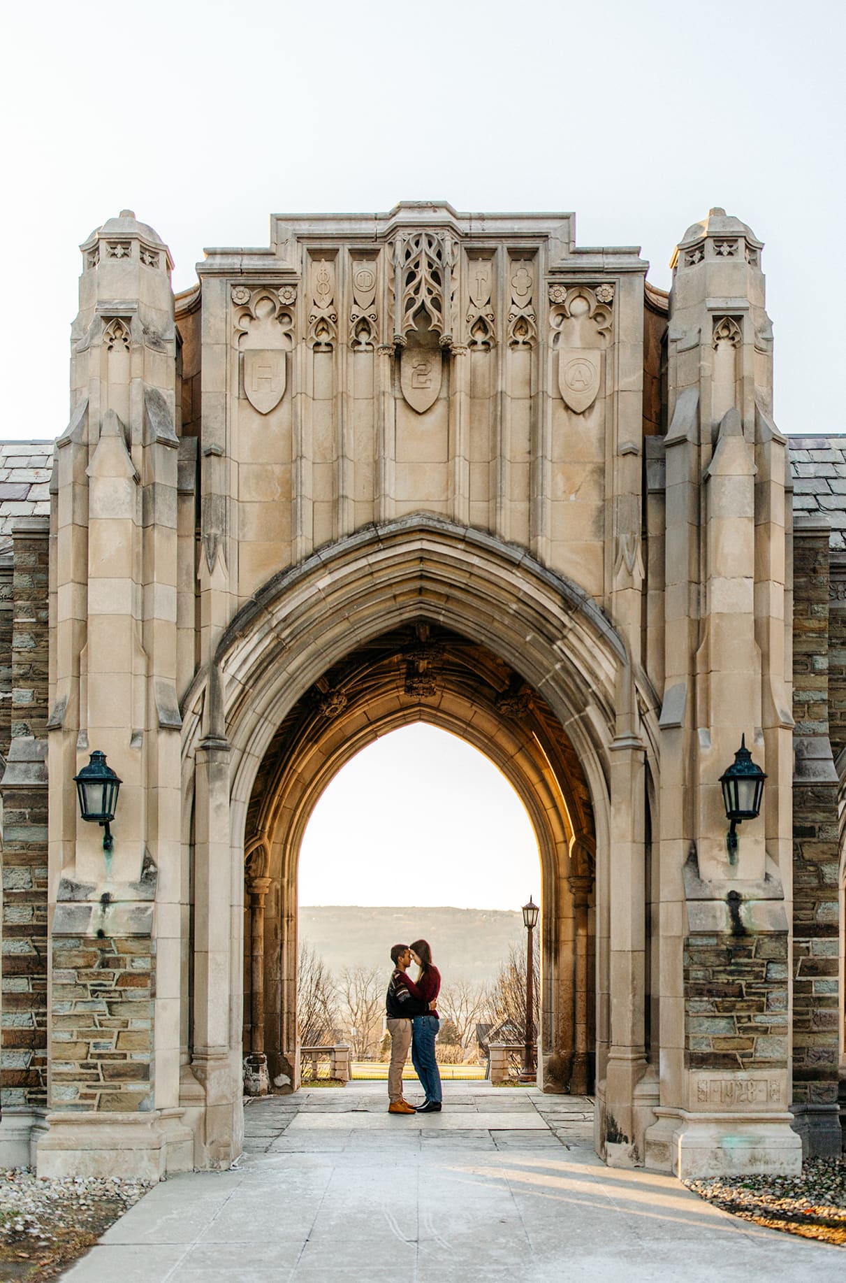 Couple embraces in doorway of the Cornell University War Memorial