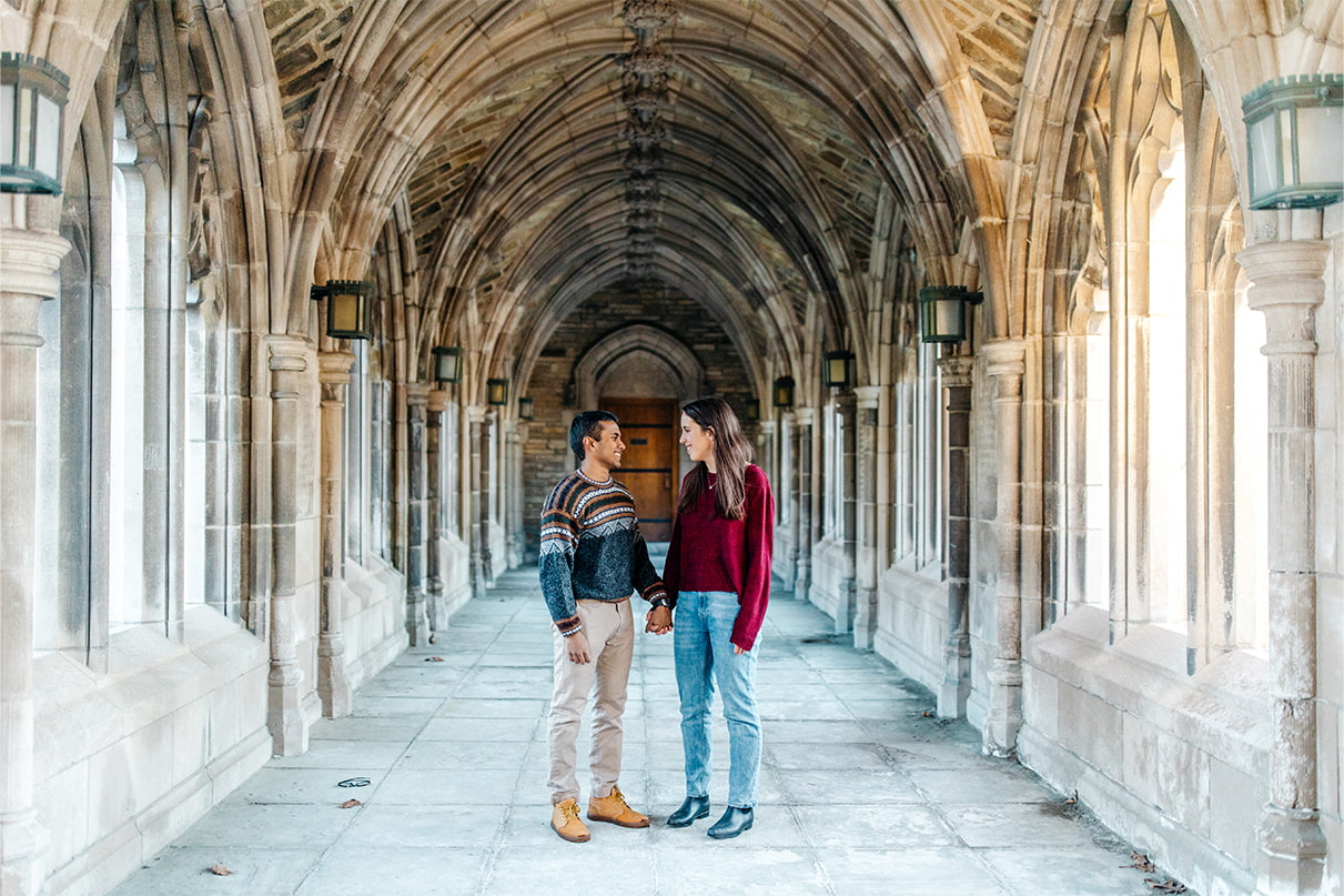 Couple holds hands in hallway at Cornell University War Memorial in Ithaca, NY