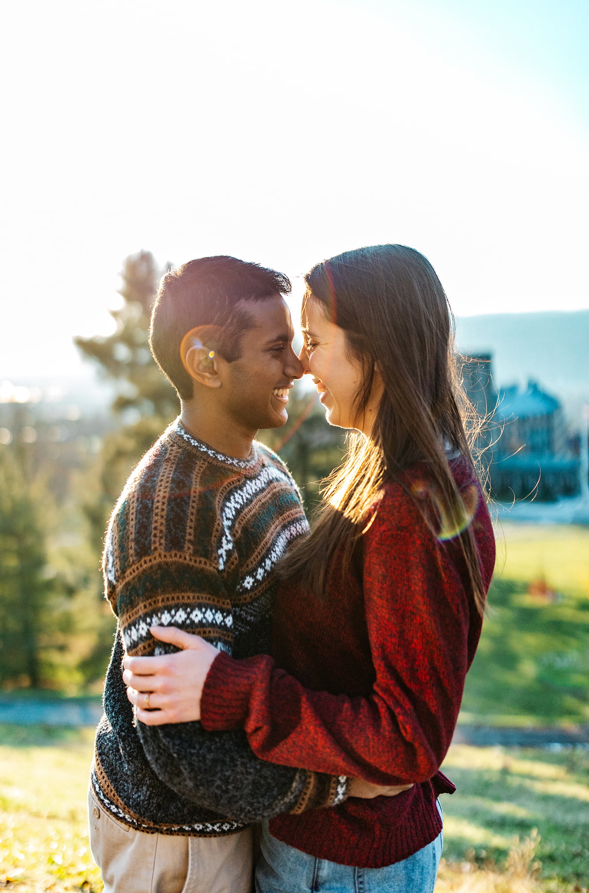 Couple embraces on hill of Cornell University in Ithaca, NY