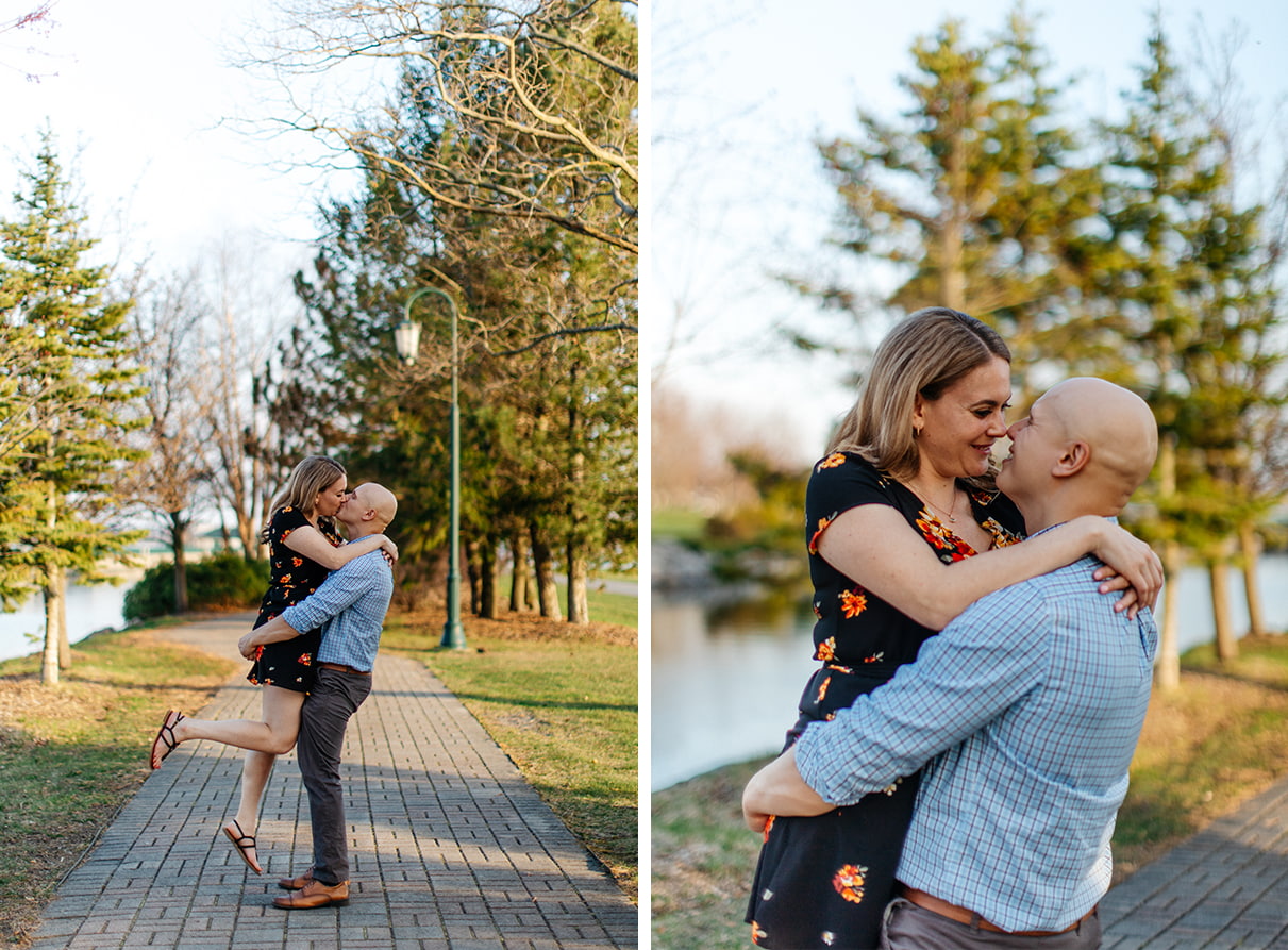 Man in blue plaid shirt lifts woman in black floral dress during engagement session