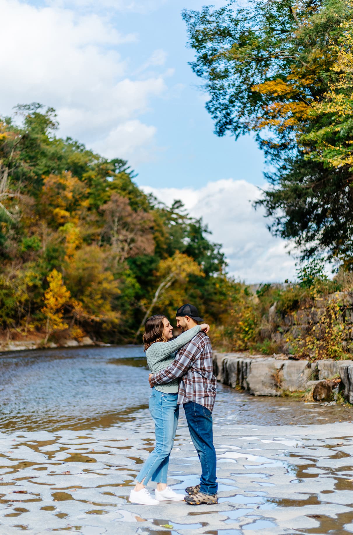 Couple standing on dry river bed in Taughannock Falls State Park in Trumansburg, NY