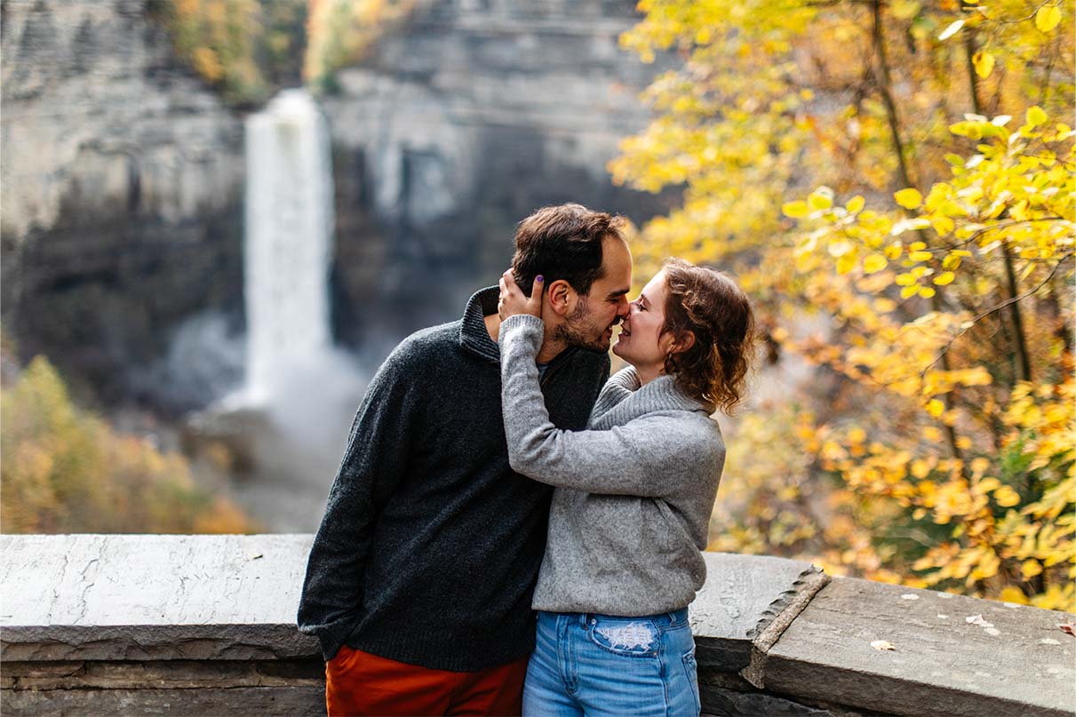 Couple kisses at falls overlook in Taughannock Falls State Park