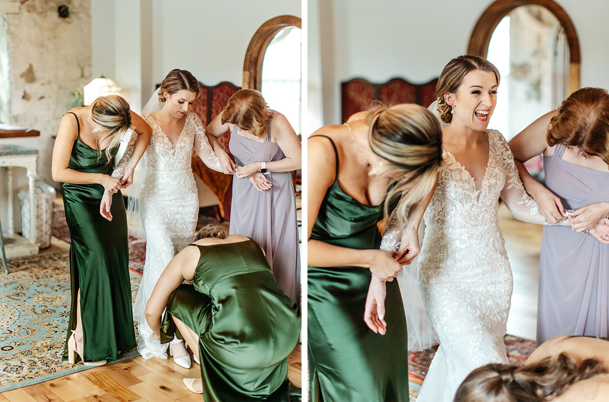 Bride's mother and bridesmaids fasten the buttons of her sleeves while she laughs in the bridal suite at The Sinclair of Skaneateles in Skaneateles NY