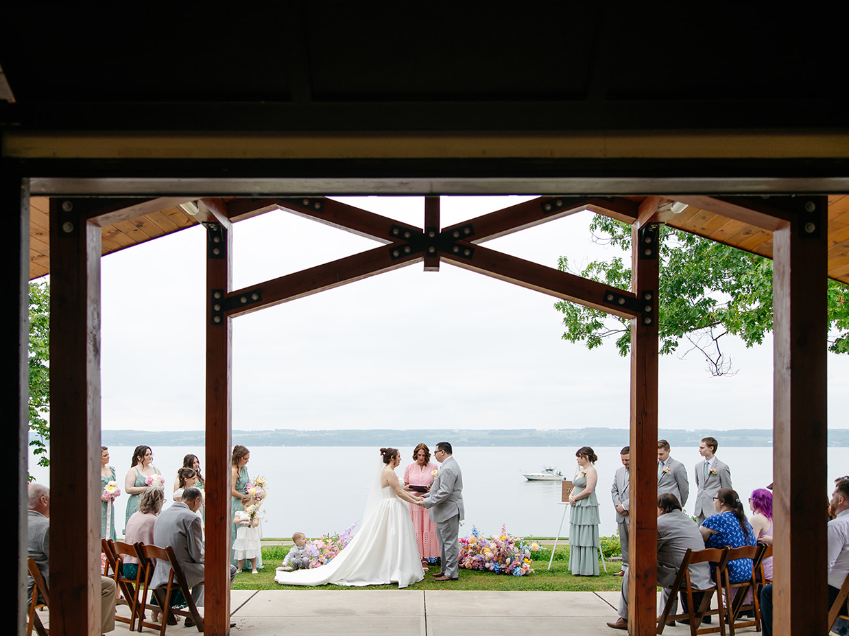 Bride and groom say their vows overlooking the Seneca Lake during their wedding at The Vista at Seneca Lake Resorts in Romulus, NY