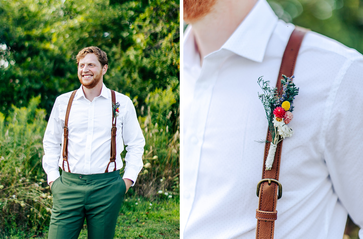 Groom in white shirt, brown leather suspenders, and green pants smiles