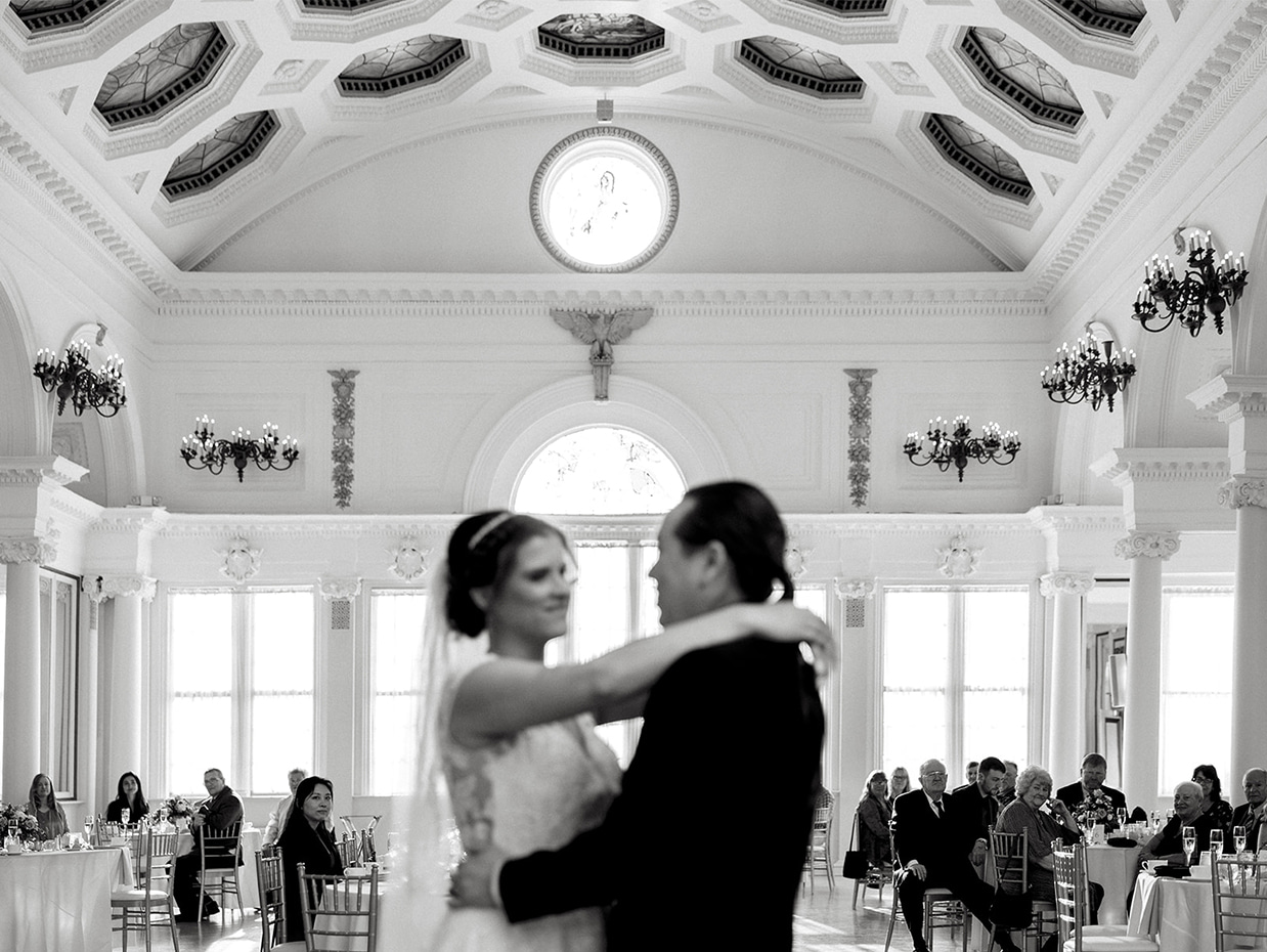 Guests watch as bride and groom share their first dance in the ballroom of Canfield Casino in Saratoga Springs NY