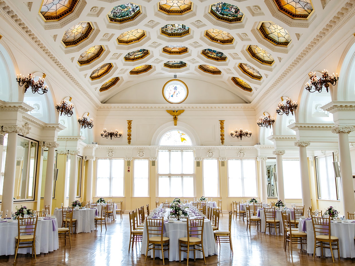 Historic wedding venue interior in New York’s Capital Region with ornate ceiling and reception tables
