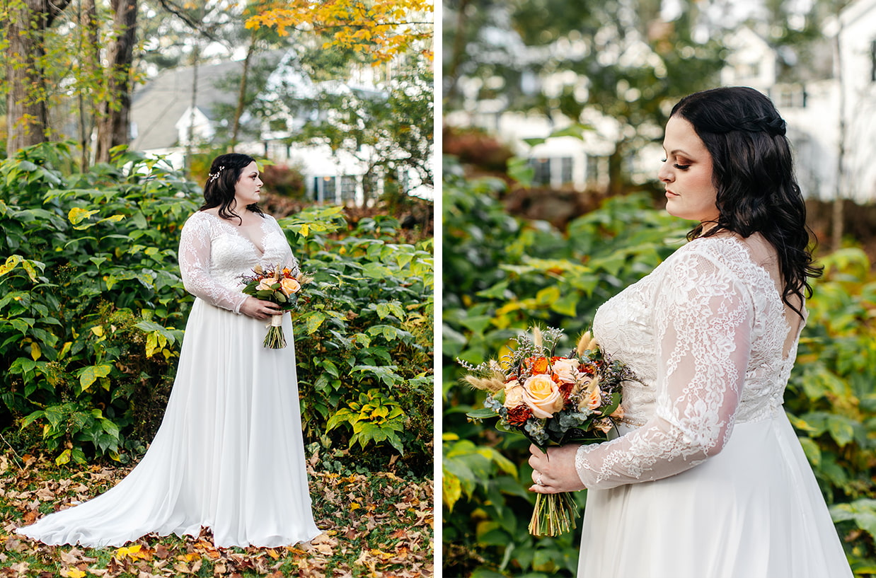 Bride holding orange and peach bouquet stands in front of beautiful greenery and fall foliage during her wedding in the catskills