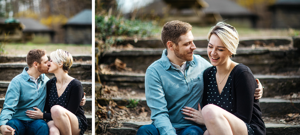 Couple kisses and smiles sitting on stone steps Ithaca NY engagement photos
