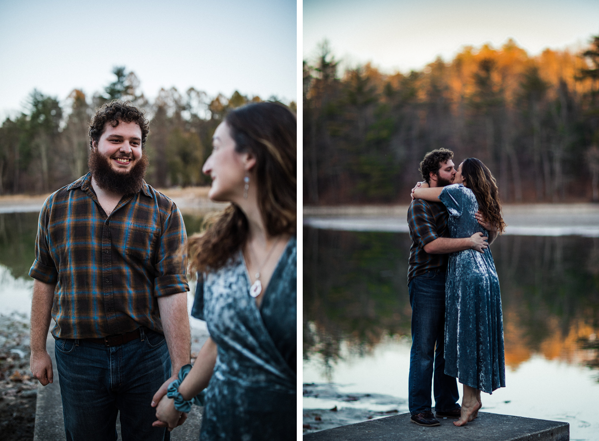 Couple kisses on dock overlooking lake during sunset engagement session