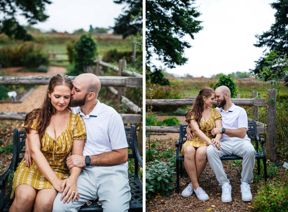 couple embrace on garden bench for engagement photos