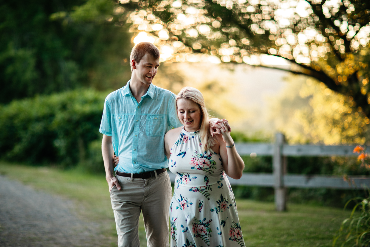 Couple walks holding hands in front of sunset in Keith Clark Park