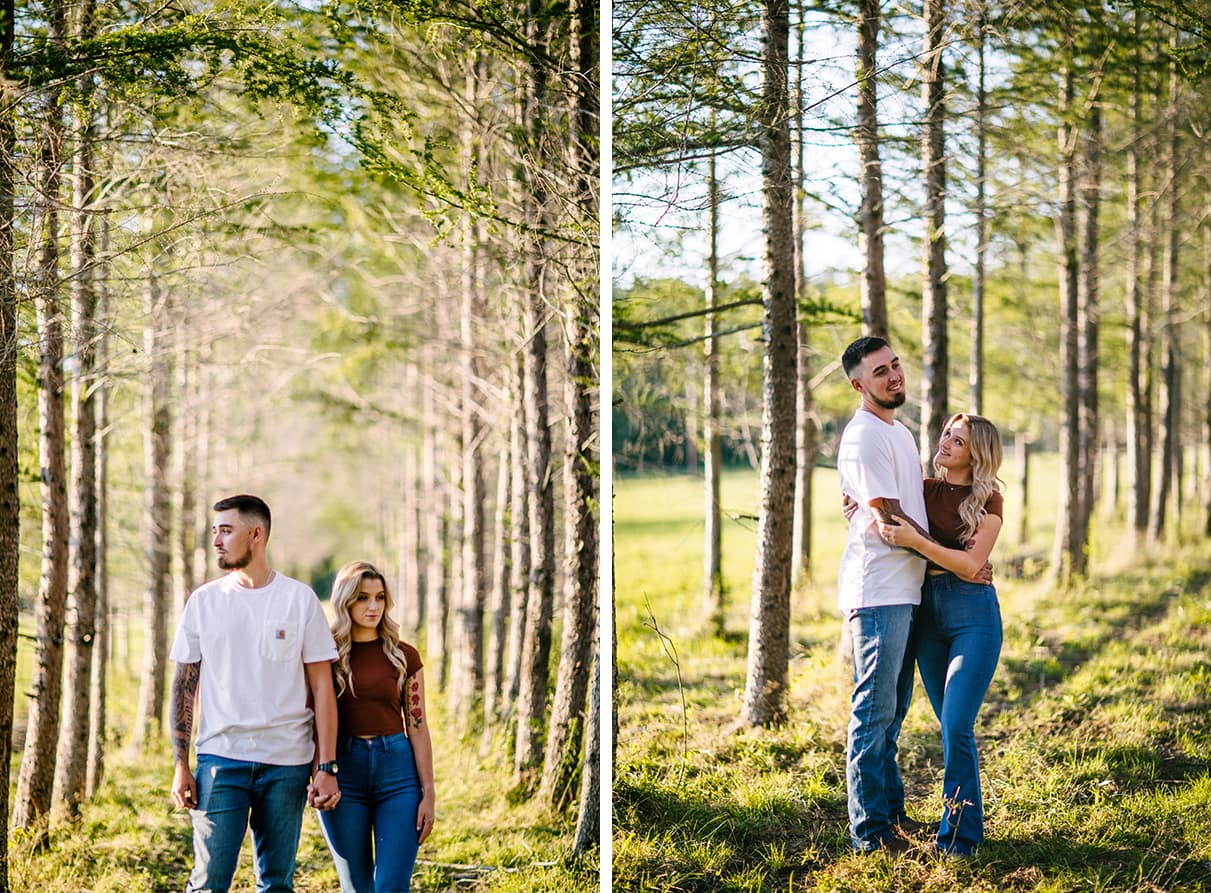 couple in cowboy boots embrace in forest of trees