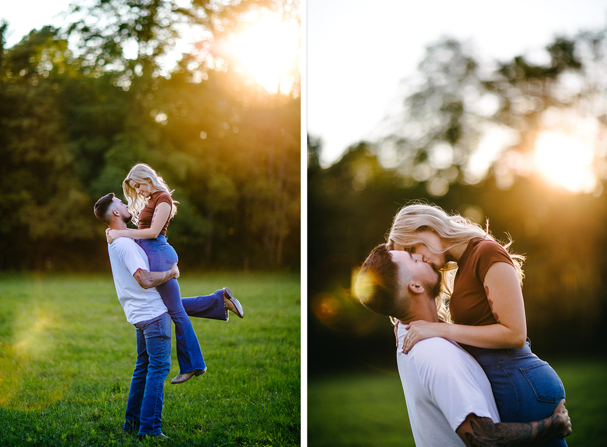 Man lifts woman as she kisses him and the sun sets behind them