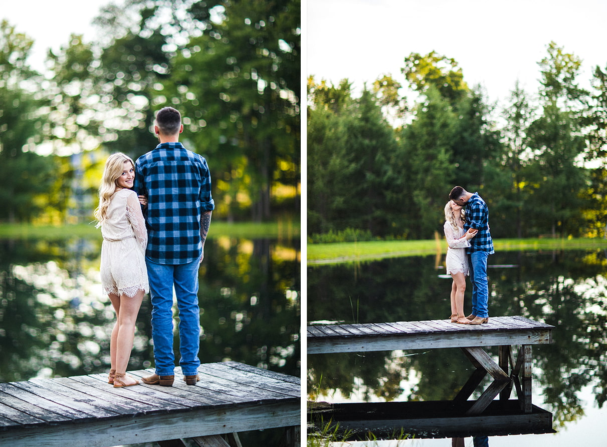 couple kissing on dock of pond and looking over shoulder