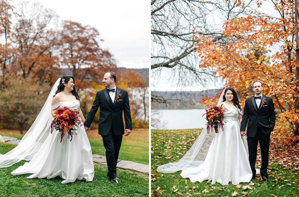 Bride and groom hold hands in front of Cayuta lake and bright orange fall foliage at the Fontainebleau Inn in Alpine NY