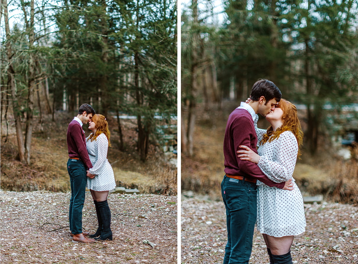 Man in purple sweater embraces woman wearing a polka dot dress for their engagement photos
