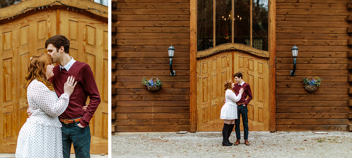 Couple embraces while standing in front of the doors to a wooden cabin