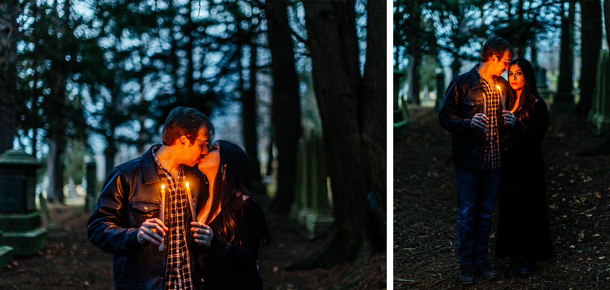 couple holds lit taper candles and kisses in a cemetery during spooky halloween couples photos