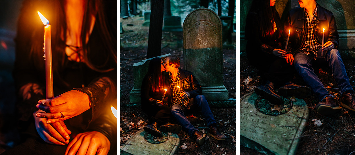 couple sits together in a cemetery against a gravestone with lit candles for halloween couples photos