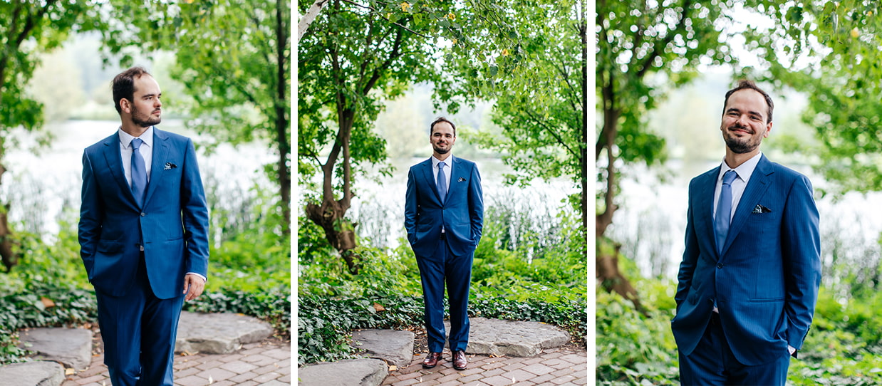Groom smiles for photos in front of lush greenery and Cayuga Lake