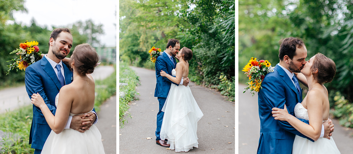 Bride and groom wearing blue suit embrace and kiss at Ithaca Farmers Market Wedding