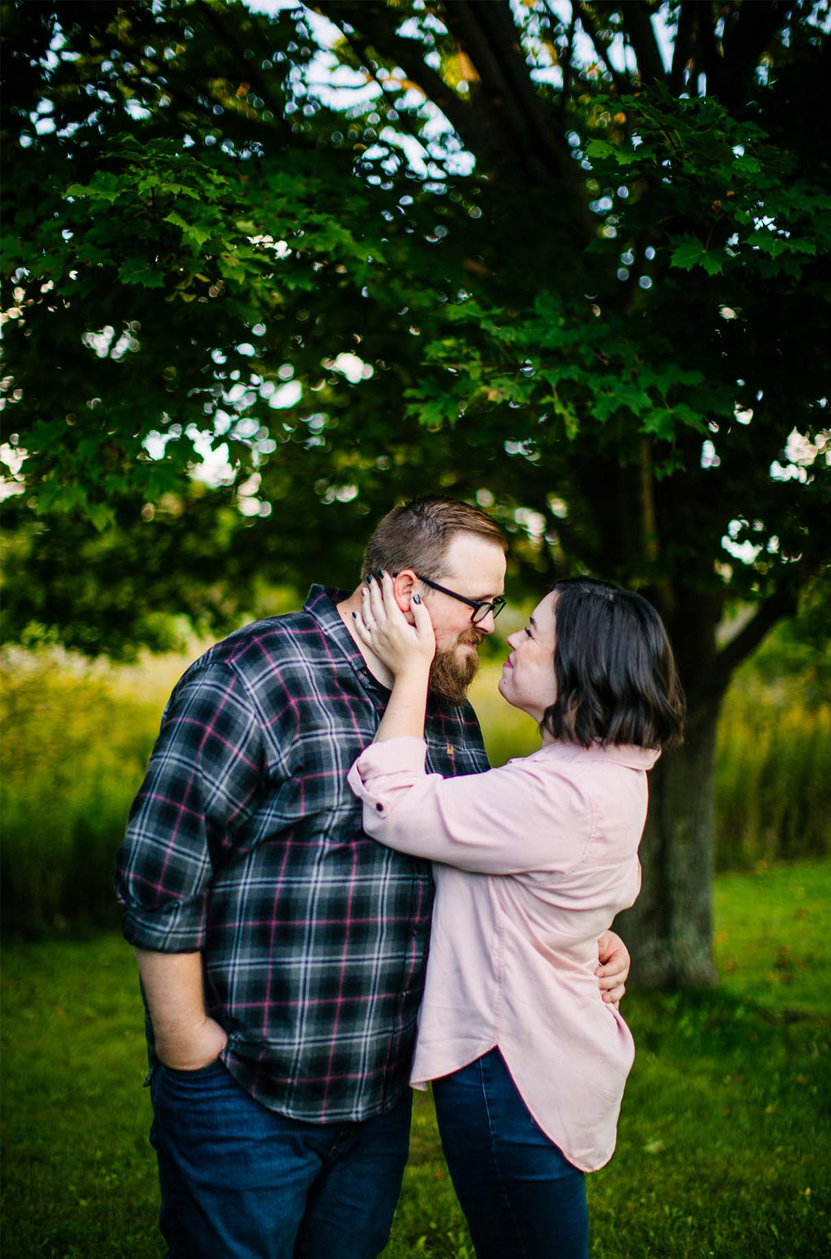 couple embraces during engagement session at labrador pond near syracuse ny