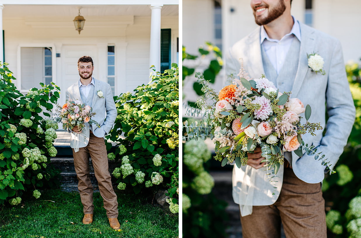 groom in tan pants and gray jacket holds brides peach and orange wedding bouquet in front of knotting hill farm in jordanville ny