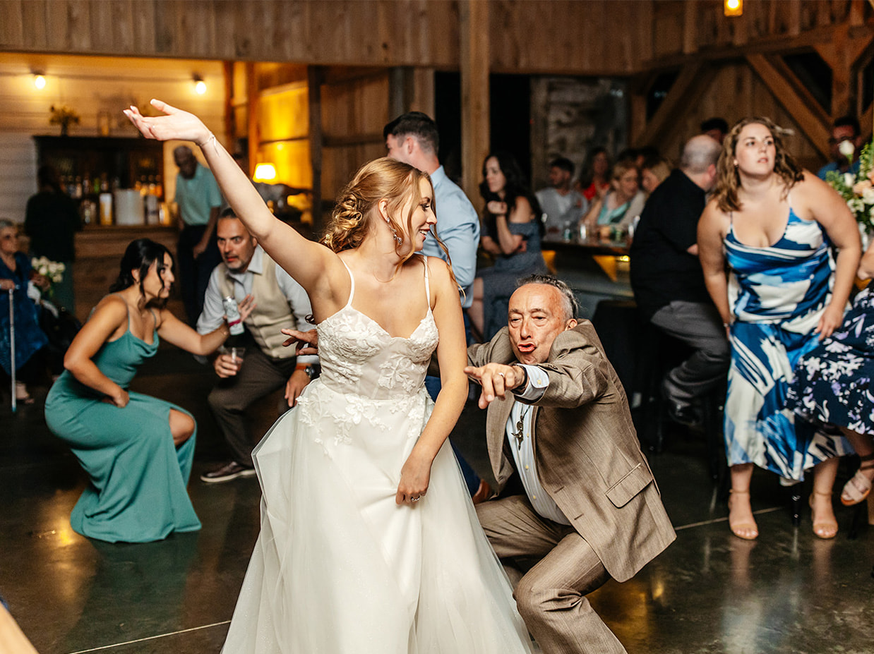 bride dances with guests during knotting hill farm wedding reception