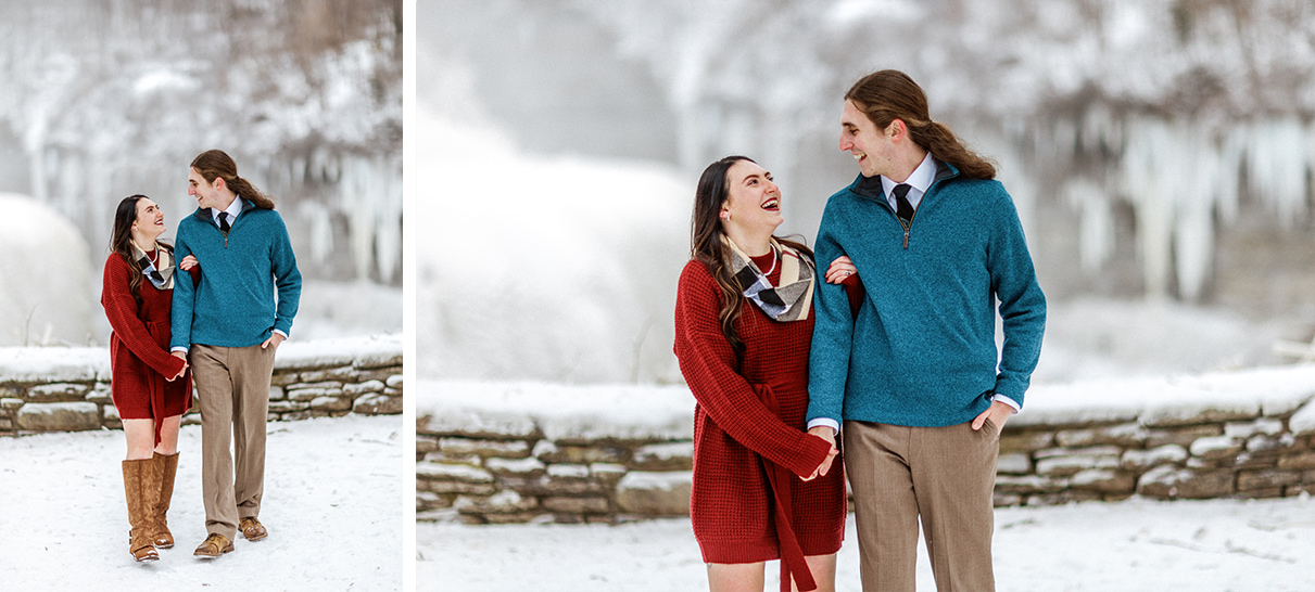 Couple walks through snow holding hands and looking at eachother during upstate ny winter engagement session