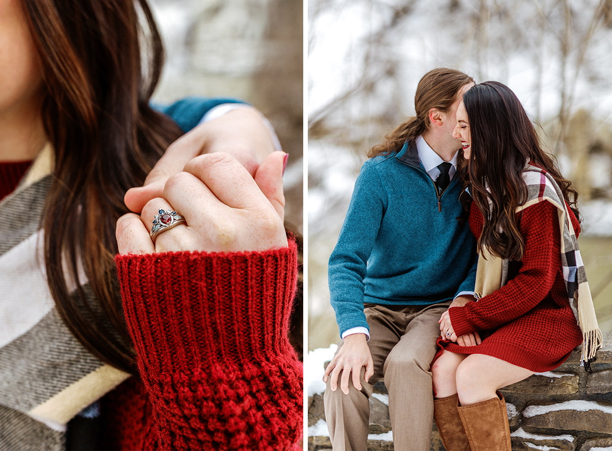 Woman in red sweater shows off engagement ring and sits on stone wall with her partner in Letchworth State Park