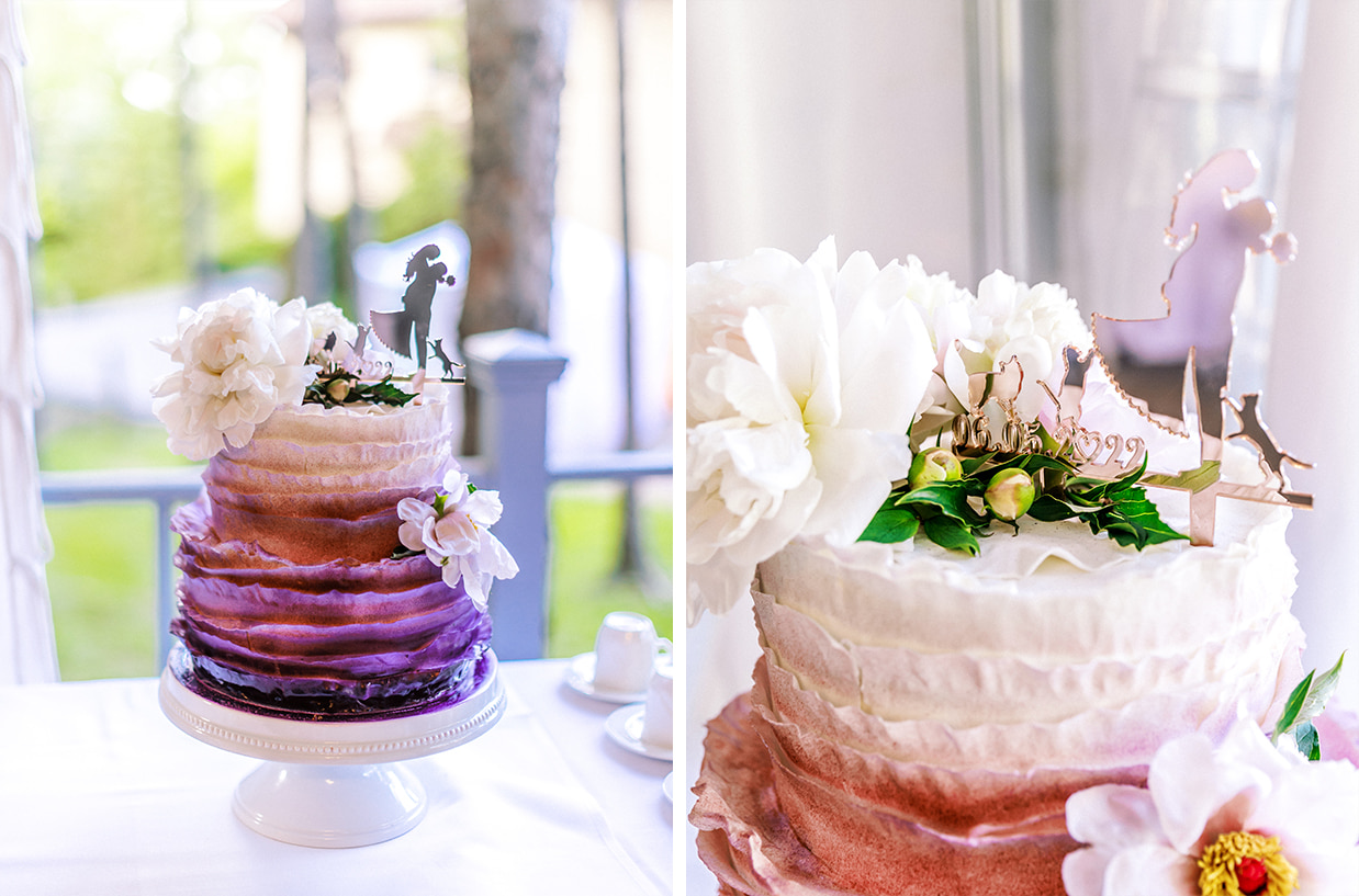 purple and white wedding cake with cat cake topper