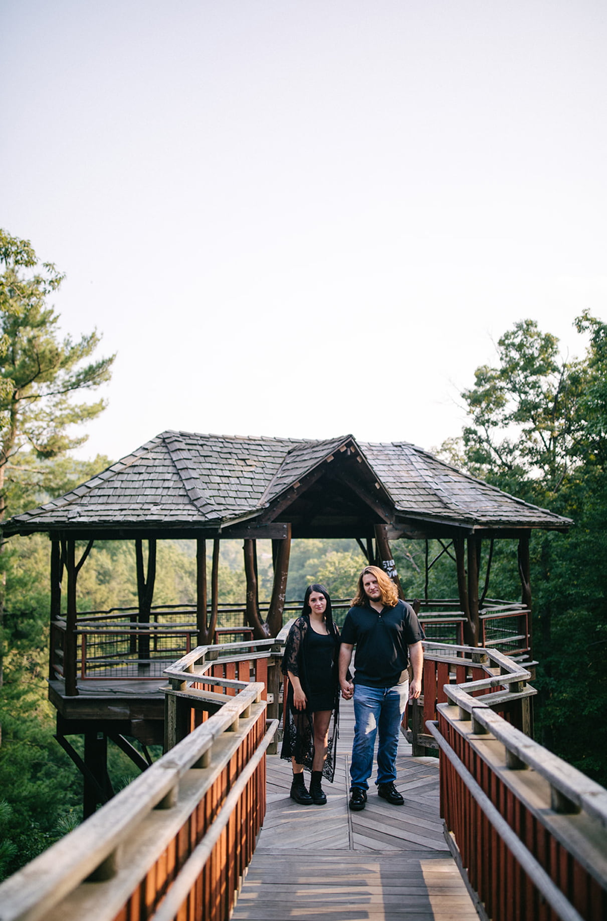 Couple holding hands in front of David Wenzel Treehouse in Nay Aug Park Scranton PA