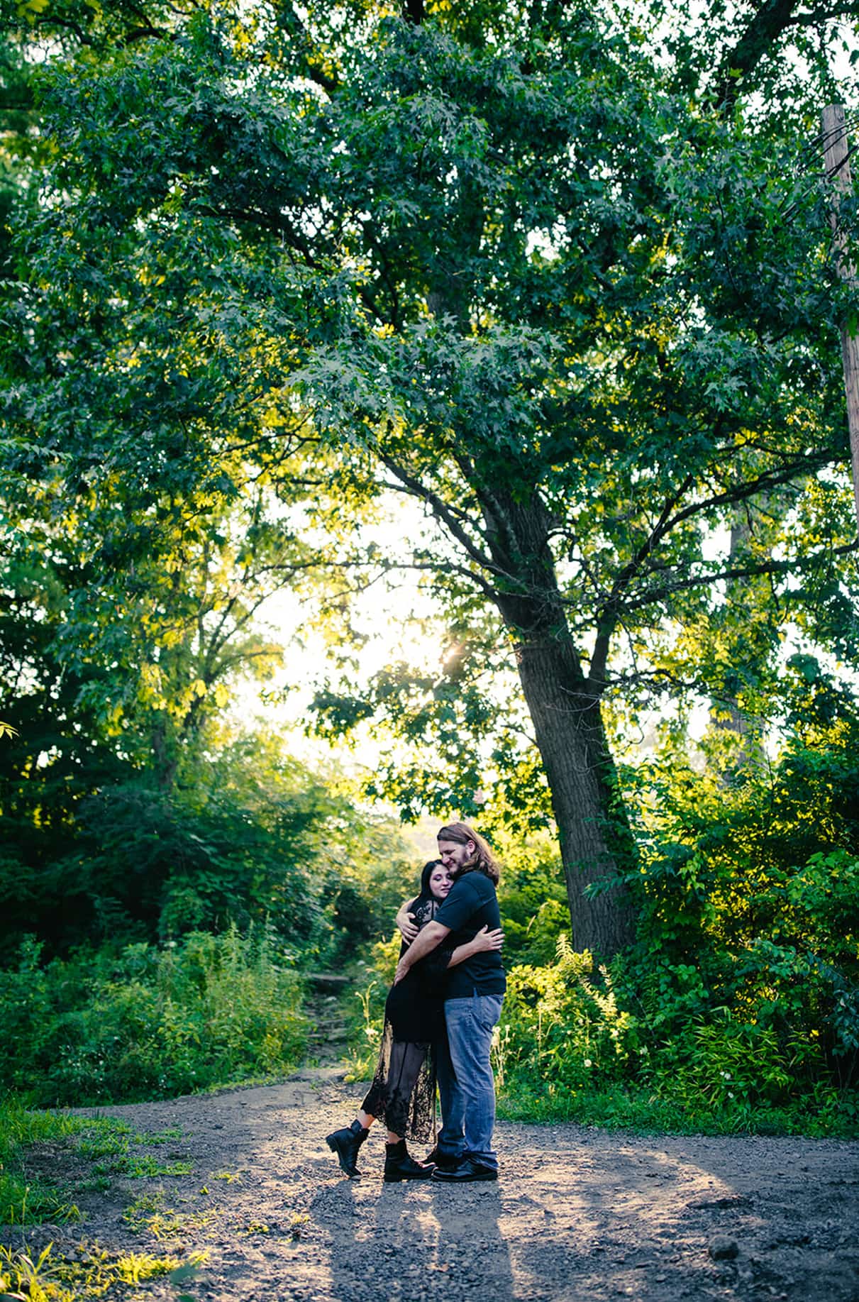 Couple embraces in front of trees in Nay Aug Park Engagement Session