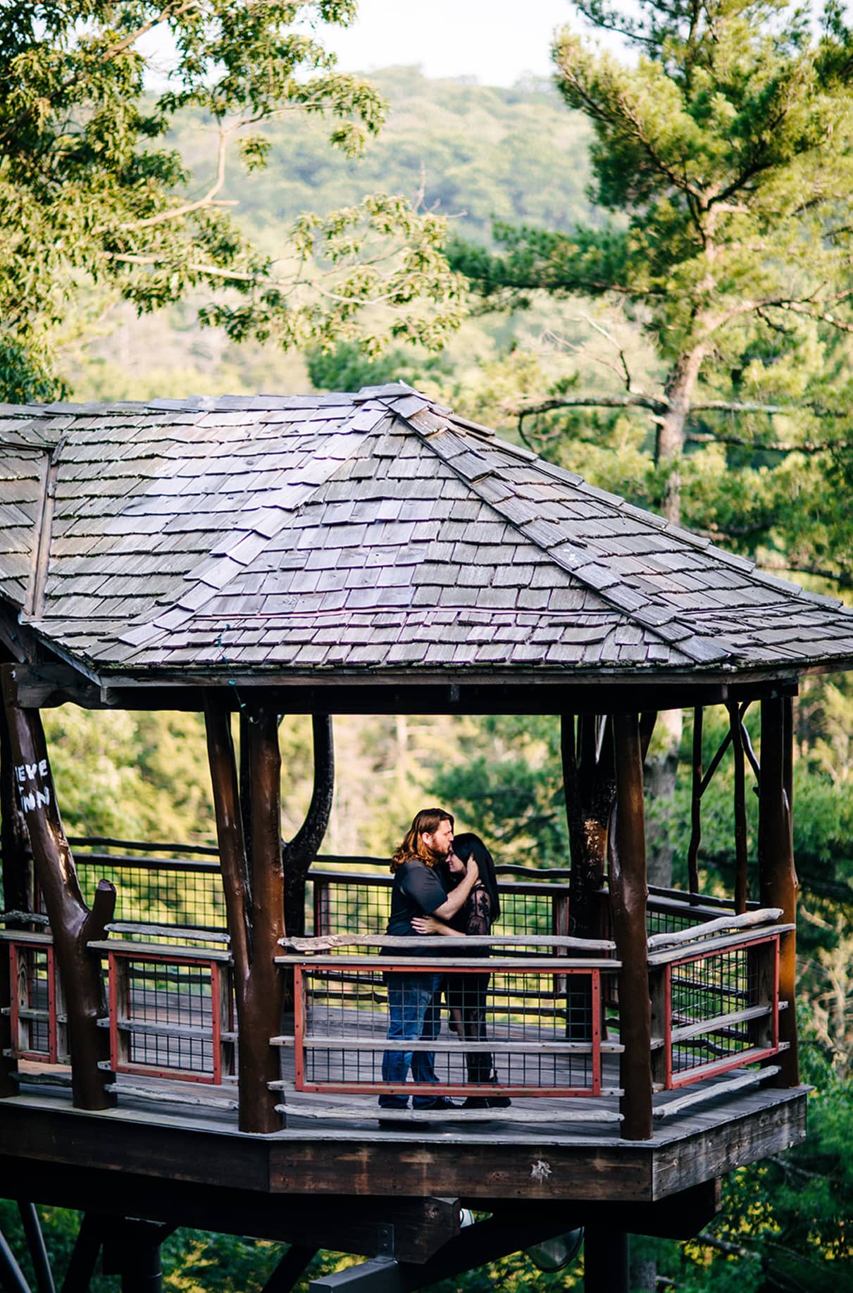 Man kisses womans forehead in David Wenzel Treehouse Nay Aug Park Scranton PA