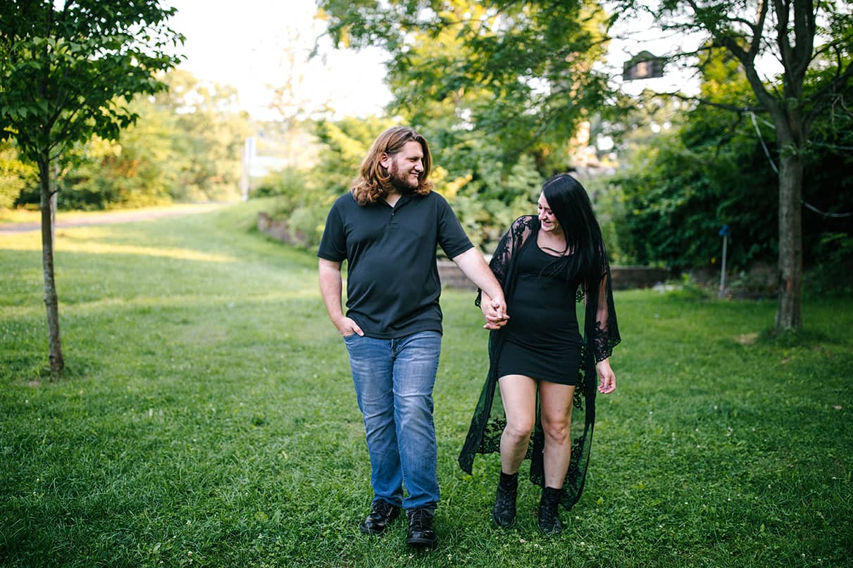 Man and woman hold hands and smile in Nay Aug Park Engagement Session