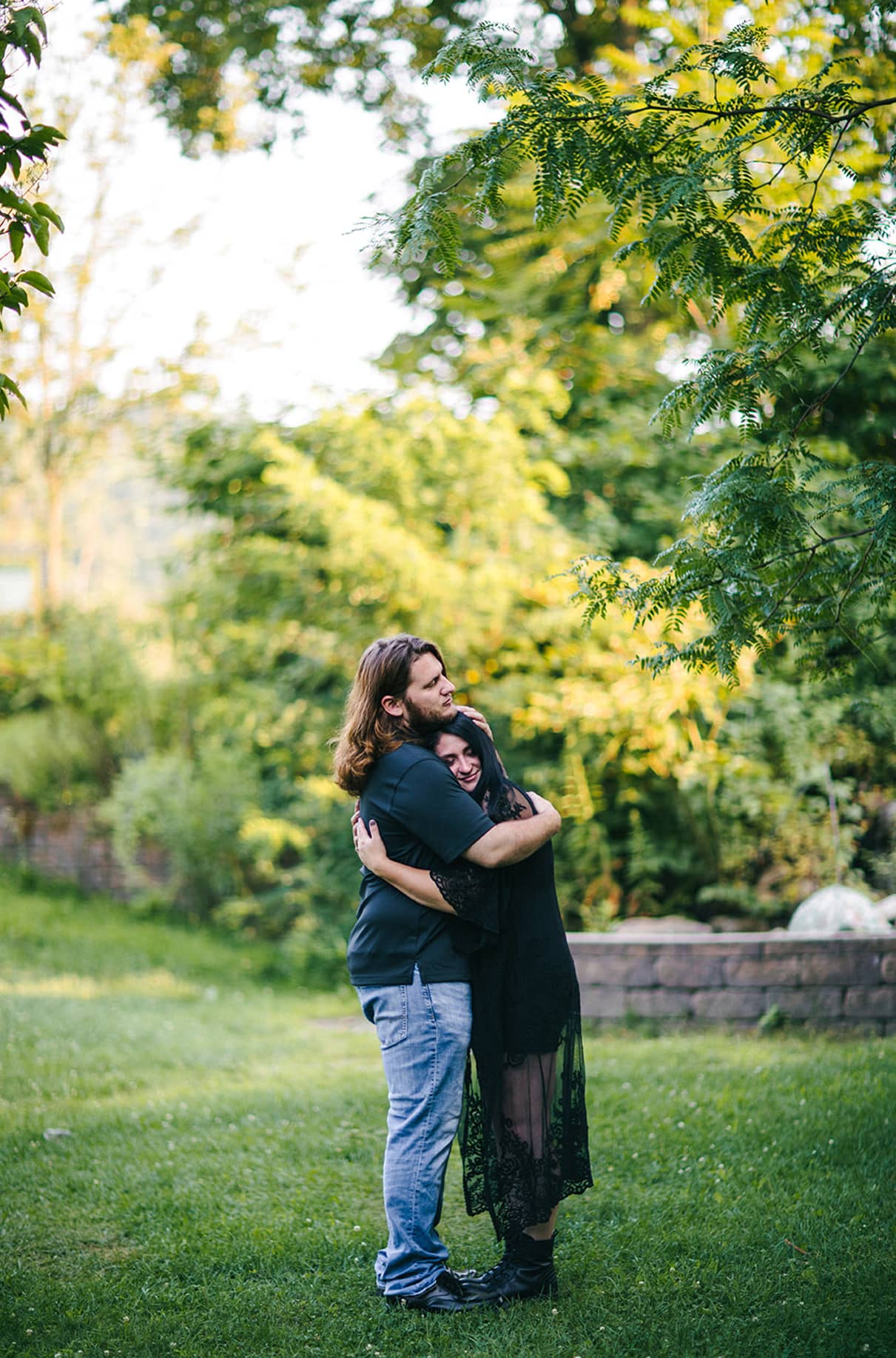 Couple hugs with womans head on mans chest in Nay Aug Park Engagement Session