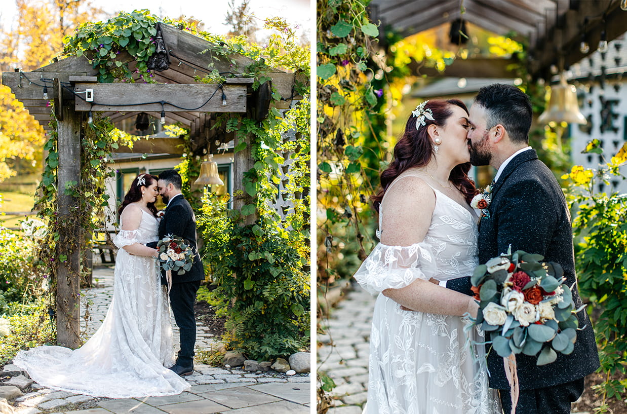 bride and groom share a kiss under greenery covered trellis at New Park Event Venue & Suites in Ithaca NY