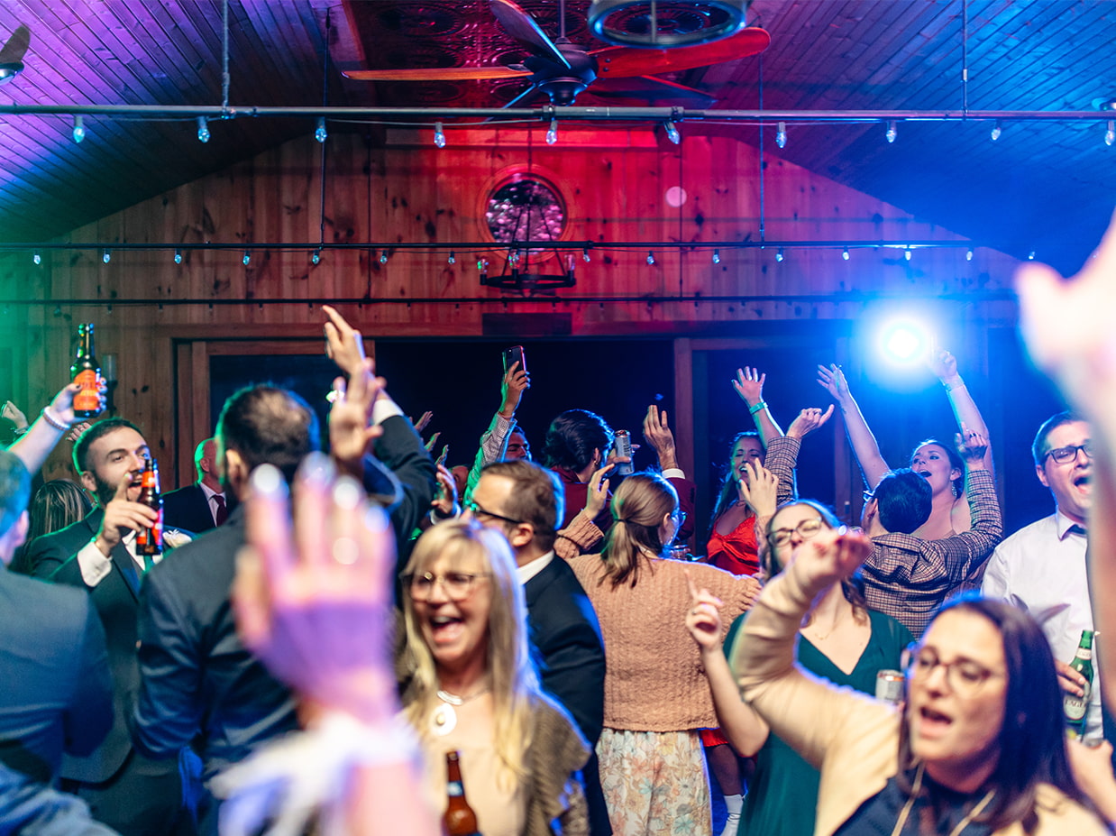 guests dancing with hands in the air at New Park Event Venue & Suites wedding reception