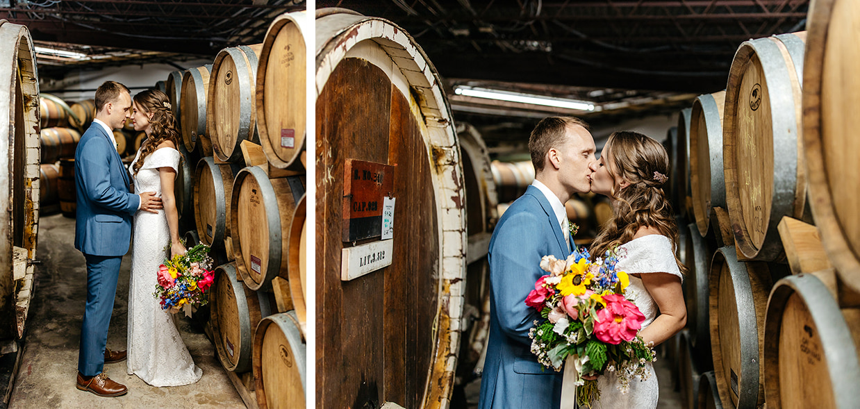 Bride and groom embrace and kiss in the Barrel room at The Ginny Lee Cafe at Wagner Vineyards